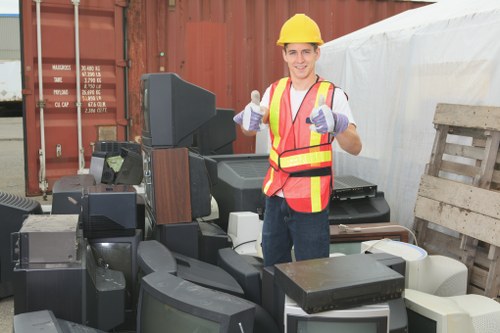 Workers managing demolition waste on a Heston construction site